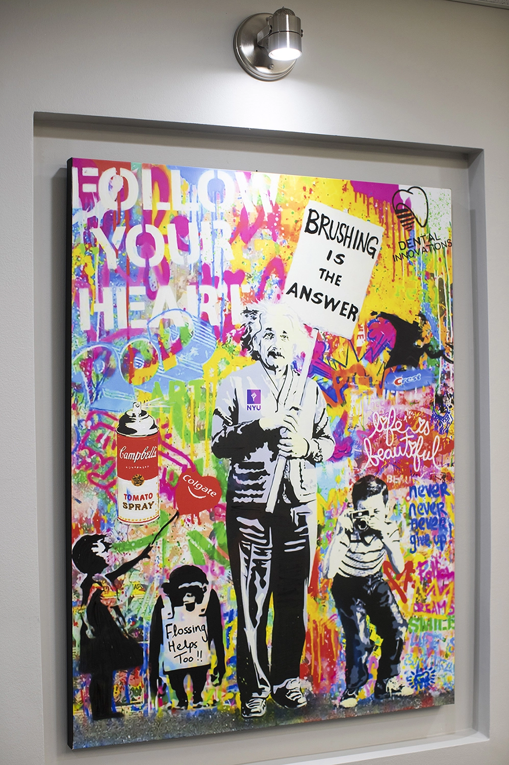 Abstract painting by Dr Ahmed. Featuring Albert Einstein holding a sign that says "Brushing is the Answer" with the text "Follow your Heart" in the top left.