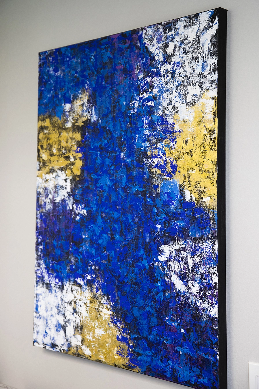 Abstract art piece featuring texture that is primarily dark blue with yellow and white.