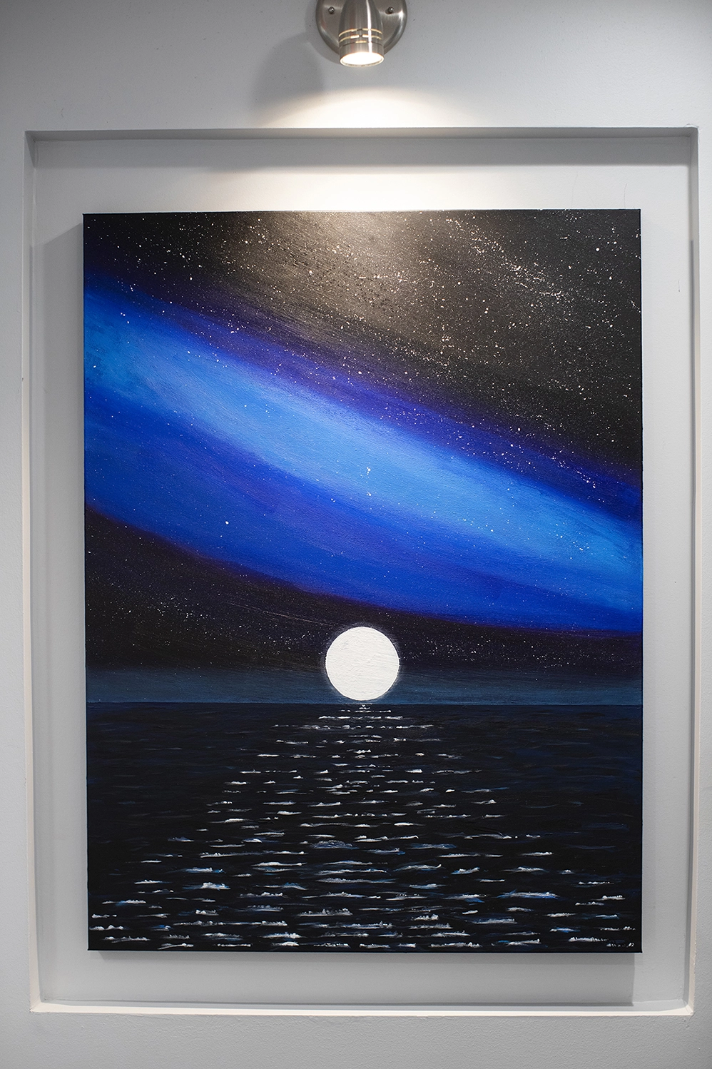 Art piece by Dr Ahmed featuring the moon over the ocean at night.