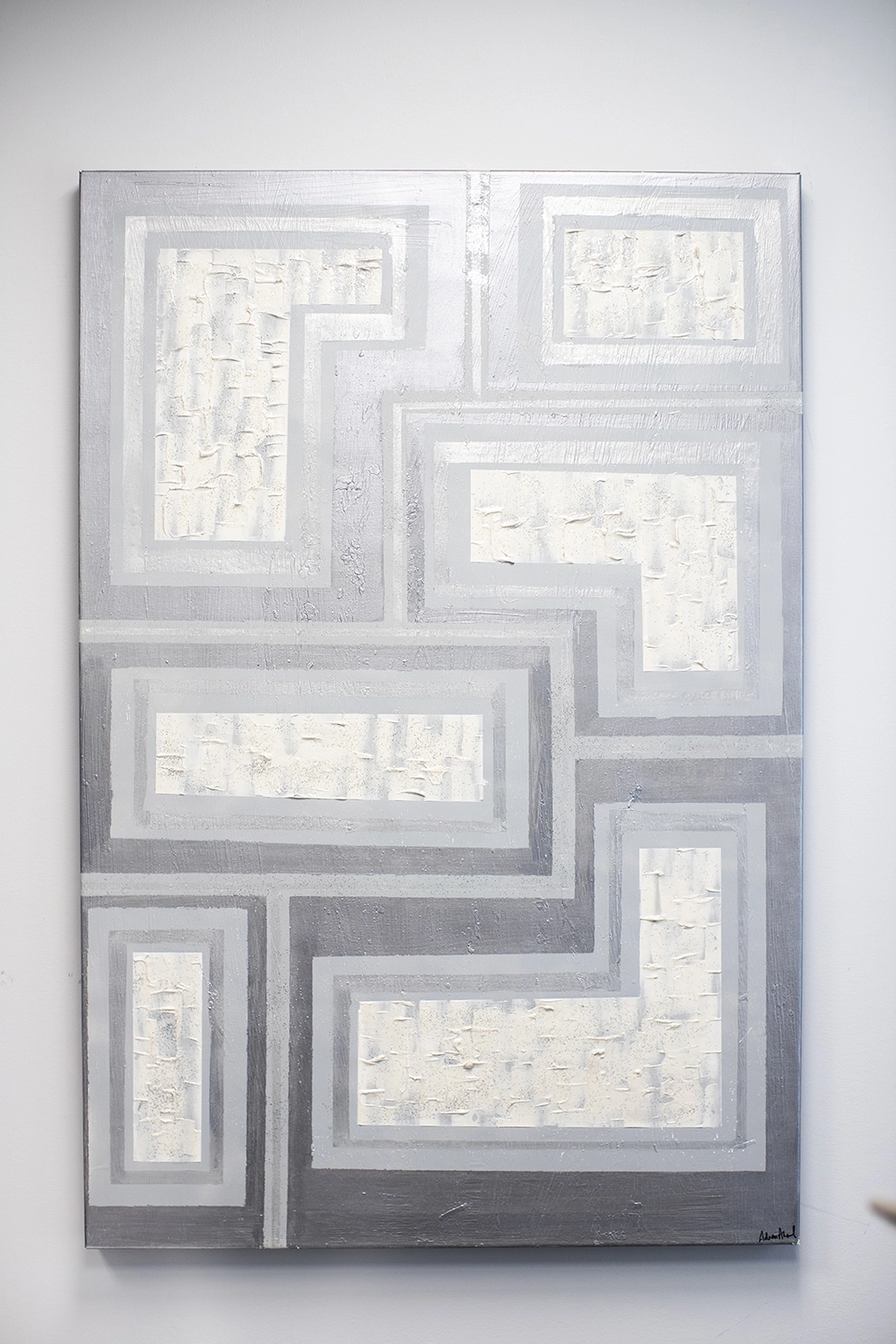 Abstract art piece by Dr Ahmed showing various shapes with gray outlines and a textured white center.