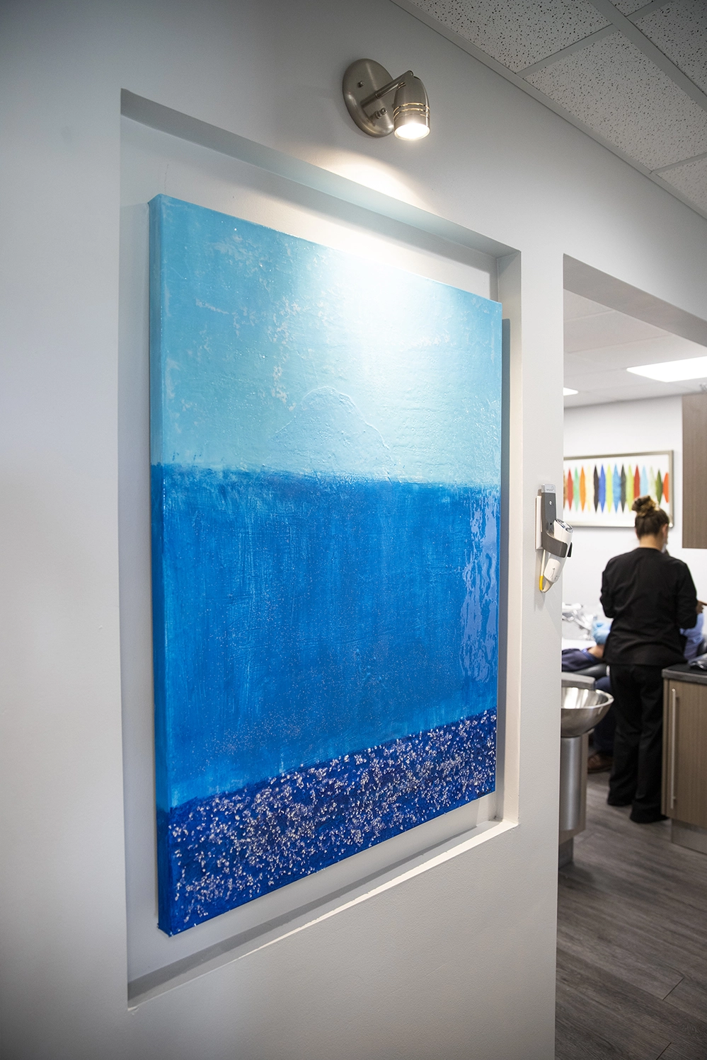Abstract art piece that shows three blue lines stacked on each other.