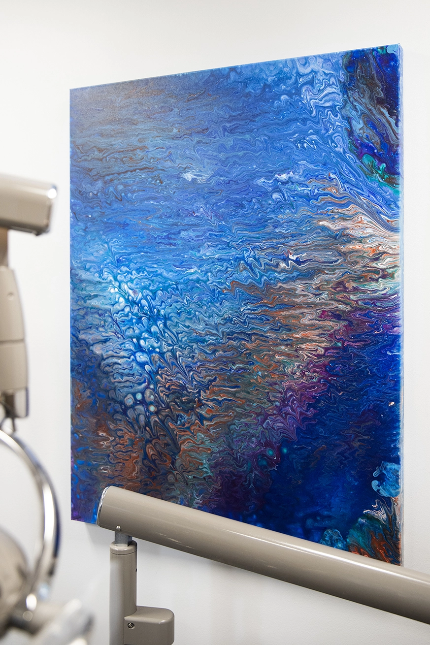 Abstract art piece showing various shades of blue and gold with texture