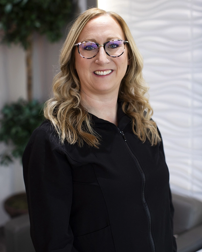 Portrait of Christine, Dental Hygienist from the waist up. Woman in hygienist uniform.