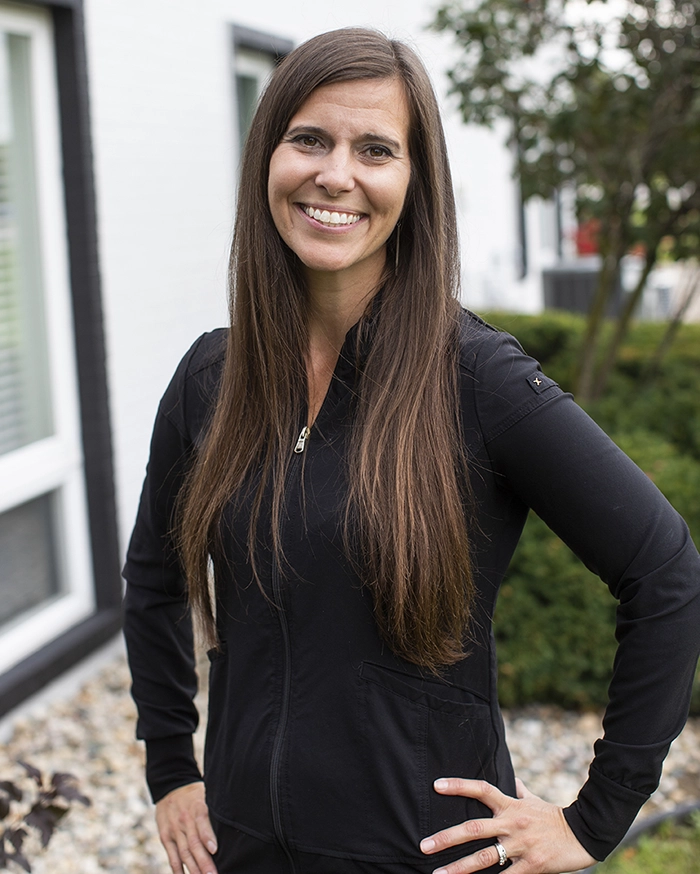 Portrait of Eva, Dental Hygienist from the waist up. Woman in hygienist uniform with brown hair.